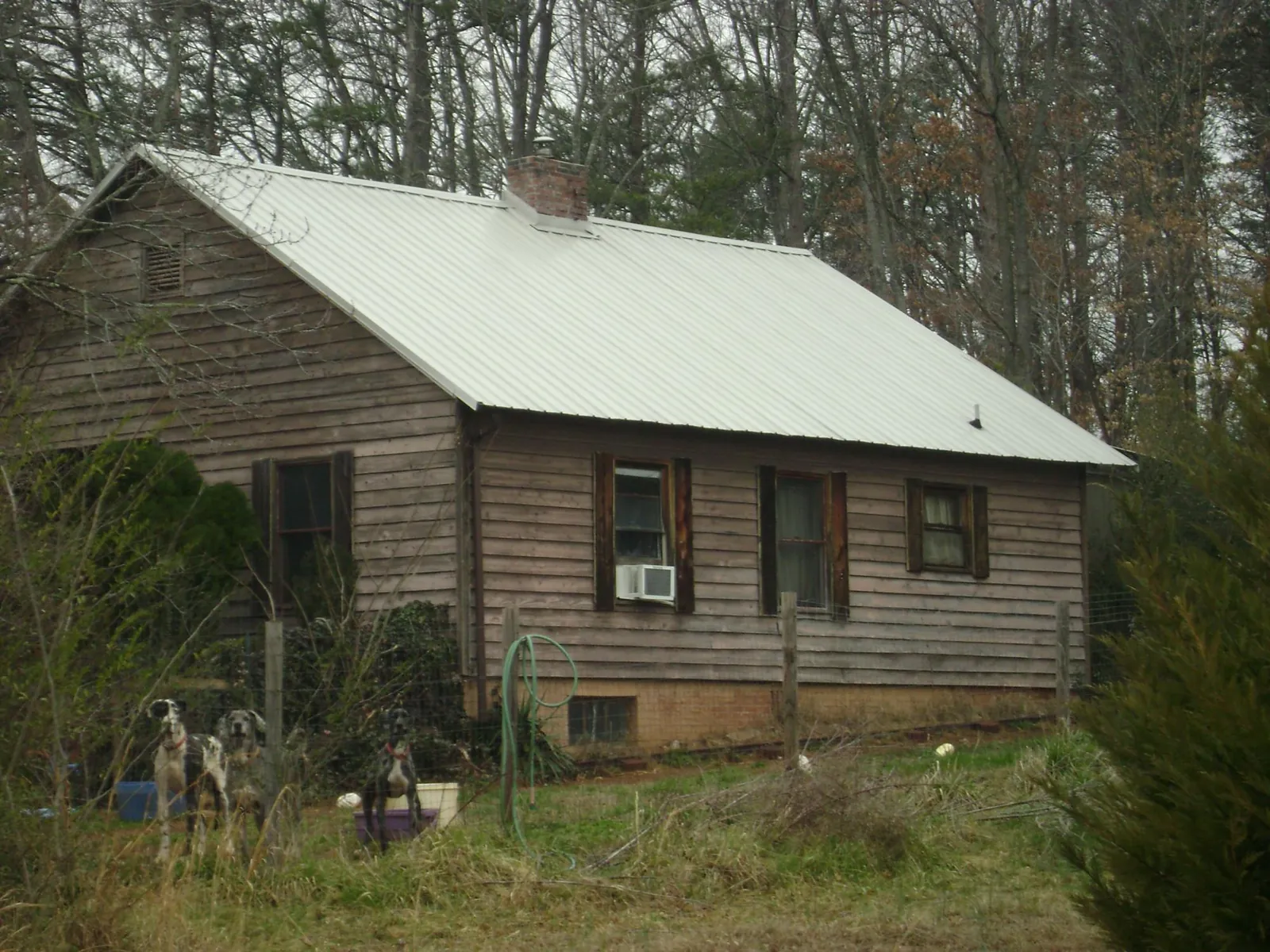 White metal roof on an old wood sided farmhouse, from a Metal Roof Installation job in South New Berlin